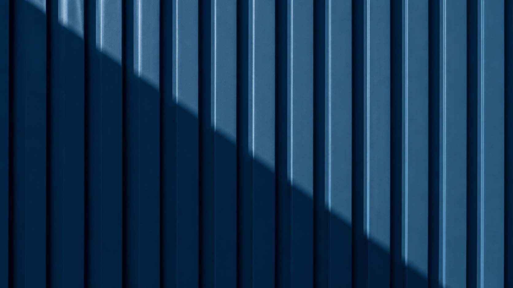 A tight abstract frame of painted, weathered industrial steel